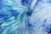 Load image into Gallery viewer, This lycra features an 8 stretch in a fun tie dye design, with colors of shades of blue, aqua blue and hints of white. 
