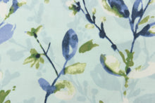 Load image into Gallery viewer, This beautiful fabric features a floral design in shades of blue, white, and green against a pale blue background. 
