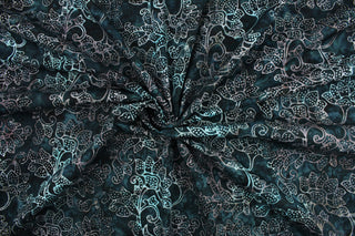 This fabric features a large floral design in dull white on a dark slate background.  It has a nice soft hand and would be great for quilting, crafting and home decor.  