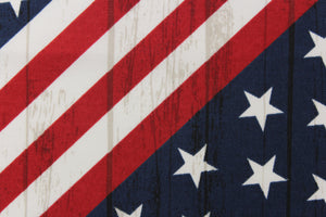 This fabric features an American flag in a diagonal direction with a wood grain look. 