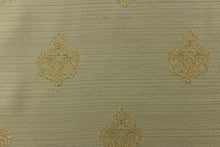 Load image into Gallery viewer, This elegant jacquard fabric features a woven ornamental damask medallion with hints of champagne or light gold on a pale green background. 
