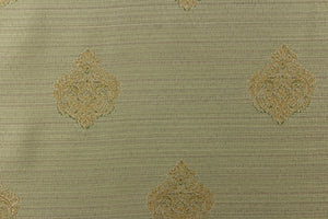 This elegant jacquard fabric features a woven ornamental damask medallion with hints of champagne or light gold on a pale green background. 