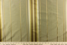 Load image into Gallery viewer, This stunning yarn dyed fabric features a multi width striped pattern in colors of gold, light gray, peach and khaki or beige. 
