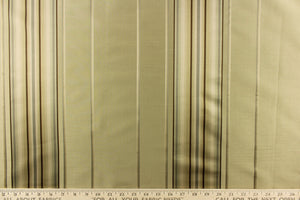 This stunning yarn dyed fabric features a multi width striped pattern brown, gray, and khaki with undertones of green.