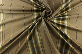 This stunning yarn dyed fabric features a multi width striped pattern in old gold, gray, light khaki against a gray brown. 