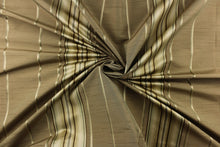 Load image into Gallery viewer, This stunning yarn dyed fabric features a multi width striped pattern in gold, brown, gray, and cream or champagne.
