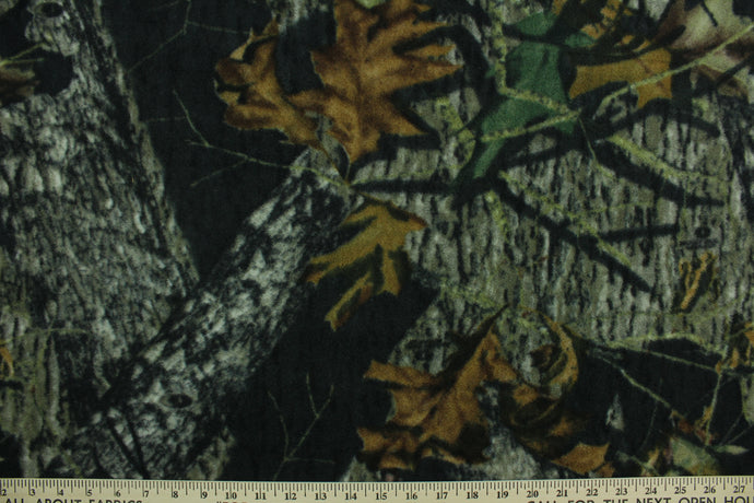 This ultra soft, medium weight printed fleece is the go to fabric for warmth.  The camouflage design features realistic branches and leaves in the colors of green, gray and brown on a black background.  It is perfect for creating jackets, vests, scarves, gloves, throws, bedding and more! 