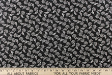 Load image into Gallery viewer,  This fabric features a whimsical floral design in white on a black background.
