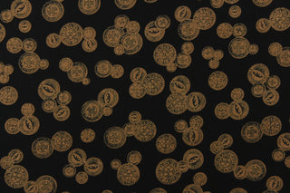  This elegant quilting print features vintage buttons in a copper or khaki color in different sizes set against a black background. 