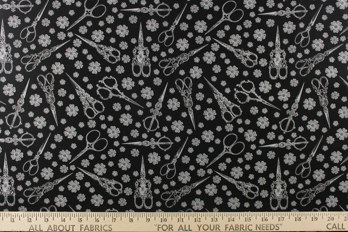  This elegant quilting print features vintage scissors in a mix of different size flowers in white against a black background