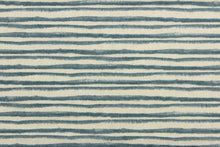 Load image into Gallery viewer,  This fabric features brushstroke stripes design in blue against pale beige .
