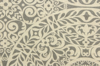 This fabric features medallion design in gray and a dull white. 
