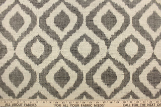 This jacquard fabric features a geometric design in black against a natural white .