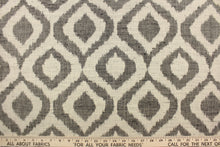 Load image into Gallery viewer, This jacquard fabric features a geometric design in black against a natural white .

