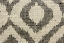 Load image into Gallery viewer, This jacquard fabric features a geometric design in black against a natural white .
