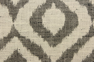 This jacquard fabric features a geometric design in black against a natural white .