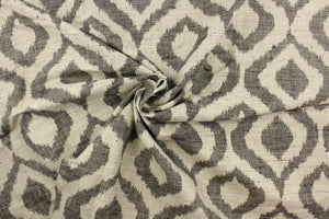 This jacquard fabric features a geometric design in black against a natural white .