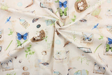 Load image into Gallery viewer,  This fabric features a butterfly and floral design in blue, green, beige, brown, off white, white and tan. 
