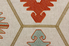 Load image into Gallery viewer, This tapestry features a vibrant embroidered Aztec design in orange. seafoam, and golden set against a light taupe.
