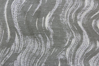 This jacquard features a vertical wavy design in gray and sliver with hints of pale purple. 