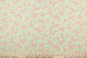 A geometric diamond design in pink set against a light green background.  