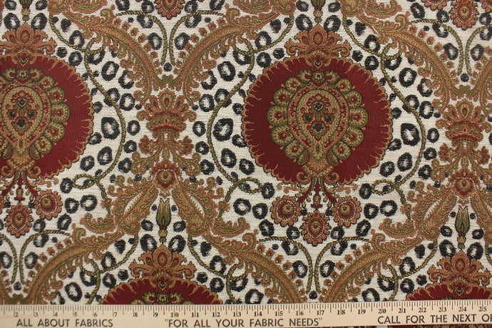 This tapestry features a beautiful medallion design in deep red, green, black, golden tan, and cream . 