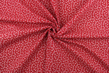 Load image into Gallery viewer,  This fabric features a tiny floral design in white set against a red background. 
