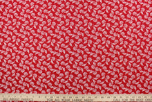 Load image into Gallery viewer, This fabric features a whimsical floral design in white on a red background. 
