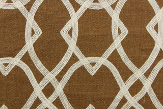 This jacquard features a geometric design of diamonds and ovals in a off white set against a dark golden tan .