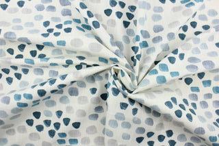 This fabric features a spot design in varying shades of blue and gray against white .