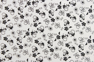 This fabric features a vine and floral design in black set against a white background.