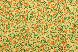  A beautiful floral design in orange and green set against a yellow background .