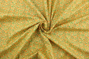  A beautiful floral design in orange and green set against a yellow background .