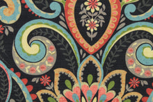 Load image into Gallery viewer, This multi use indoor/outdoor fabric features a large paisley design in red, light orange, turquoise, green, taupe and light yellow on a black background.  It is family friendly and perfect for outdoor settings or indoors in a sunny room.  It is stain and water resistant and can withstand up to 500 hours of direct sun exposure.  Uses include decorative pillows, cushions, chair pads, tote bags and upholstery.  
