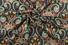 Load image into Gallery viewer, This multi use indoor/outdoor fabric features a large paisley design in red, light orange, turquoise, green, taupe and light yellow on a black background.  It is family friendly and perfect for outdoor settings or indoors in a sunny room.  It is stain and water resistant and can withstand up to 500 hours of direct sun exposure.  Uses include decorative pillows, cushions, chair pads, tote bags and upholstery.  
