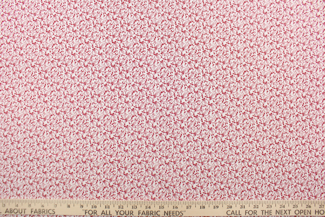 This fabric features a tiny vine design in red set against a white background .