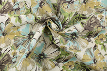 Load image into Gallery viewer, This medium weight fabric features a large floral, water color design in cream, green, brown, black, white and blue.  It is stain and water resistant and can withstand up to 500 hours of direct sun exposure and has a durability rating of 30,000 double rubs.   Uses include decorative pillows, cushions, chair pads, tote bags, slip covers and upholstery.
