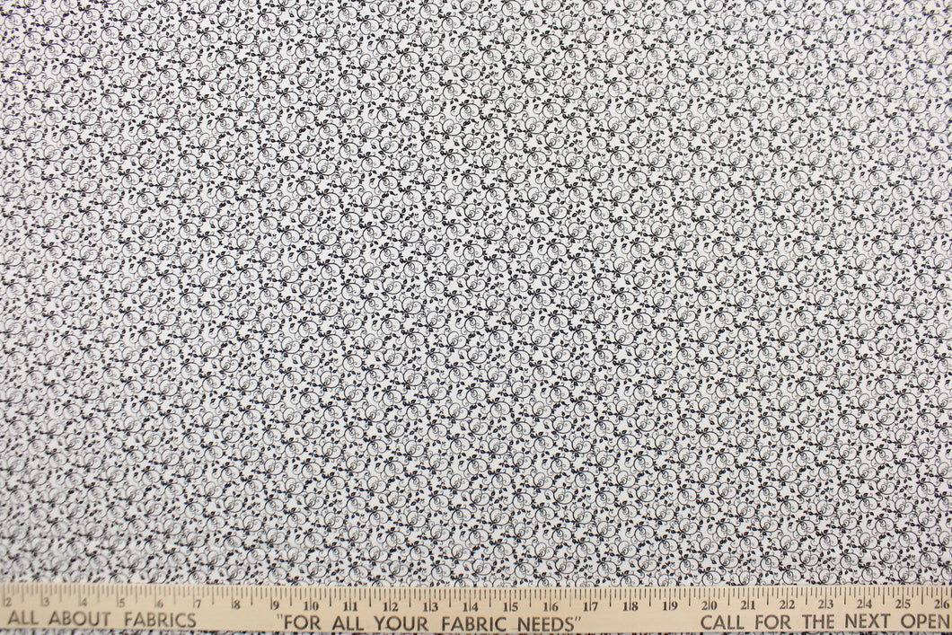 This fabric features a tiny vine design in black set against a white background .  