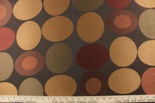 Load image into Gallery viewer, Stylish, modern and contemporary best describe this geometric pattern of circles and ovals in red, gold and brown on a dark brown background . 
