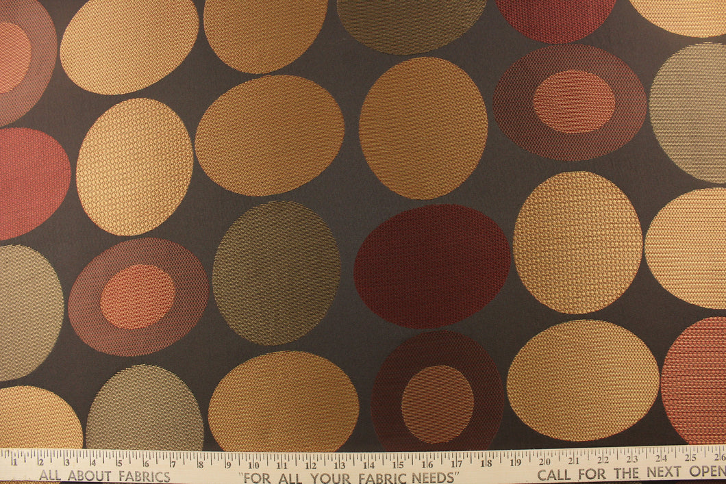 Stylish, modern and contemporary best describe this geometric pattern of circles and ovals in red, gold and brown on a dark brown background . 