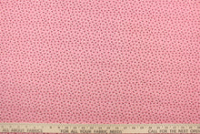Load image into Gallery viewer,  This fabric features a tiny floral design in pink, black and white set against a pink background.
