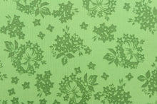 Load image into Gallery viewer,  A floral design in green .
