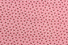 Load image into Gallery viewer,  This fabric features a tiny floral design in pink, black and white set against a pink background.
