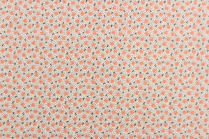   This fabric features a tiny floral design in orange and brown green set against a white background.