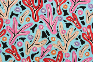  A whimsical design in in pink, nude, red, purple, orange, black, and white, set against a blue background . 