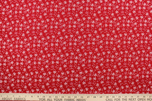 This fabric features a floral design in white set against a red background