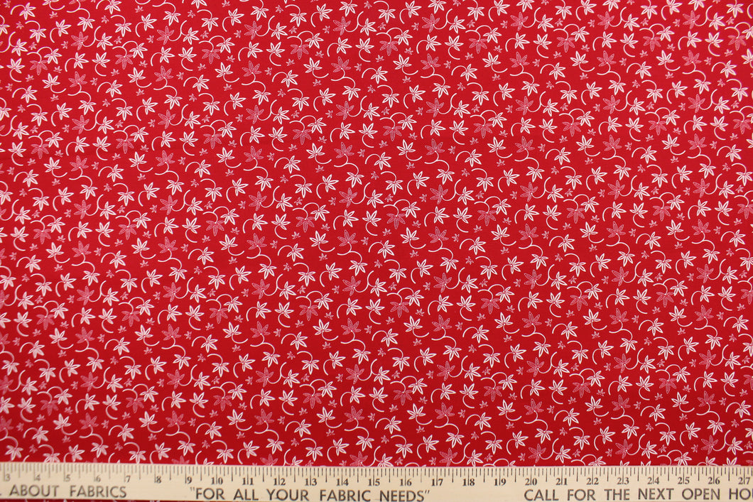 This fabric features a floral design in white set against a red background