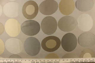 Geometric pattern of circles and ovals in gold and pewter or gray tones on a khaki background