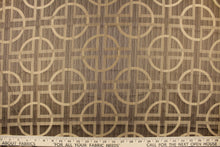 Load image into Gallery viewer, Fortran is a jacquard fabric featuring a large scale geometrical design in varying shades of brown and beige.
