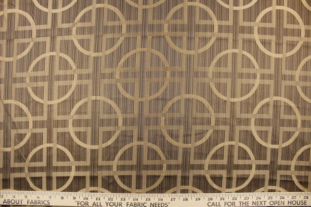 Fortran is a jacquard fabric featuring a large scale geometrical design in varying shades of brown and beige.